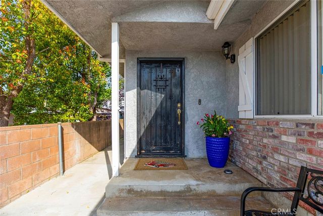 a living room with furniture a flat screen tv and a floor to ceiling window