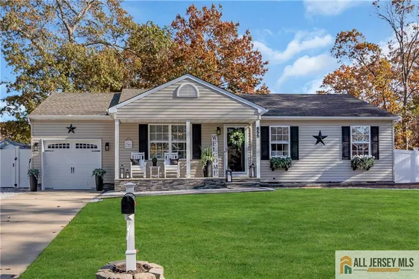 a front view of a house with a yard fire pit and outdoor seating