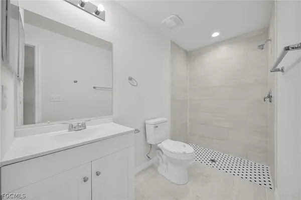 a bathroom with a toilet sink and shower