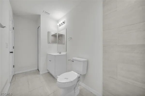 an empty room with closet and fan