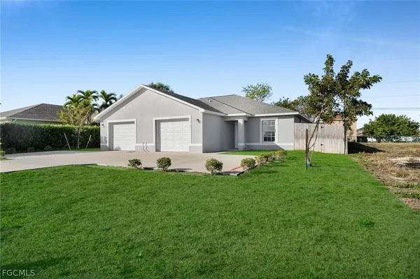 a front view of a house with a garden