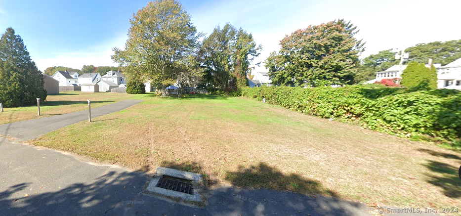 22 Charles Street Enfield, CT 06082 - Photo 1 of 1 a view of yard with swimming pool and trees in the background