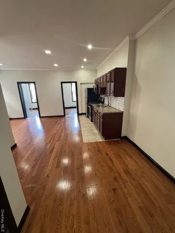 a view of a living room with wooden floor and furniture