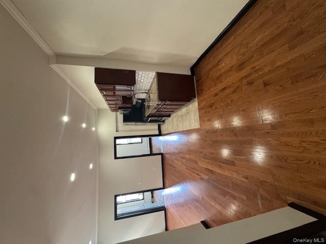 1586 Prospect Place, Unit 1R Brooklyn, NY 11233 - Photo 1 of 7 a view of a living room with wooden floor and furniture