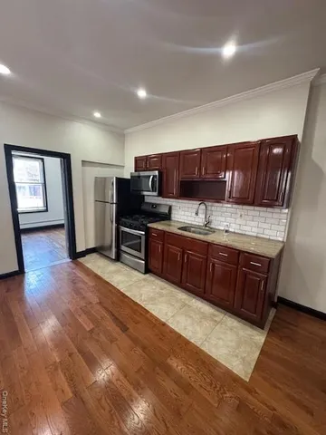 a kitchen with stainless steel appliances granite countertop a stove sink and cabinets