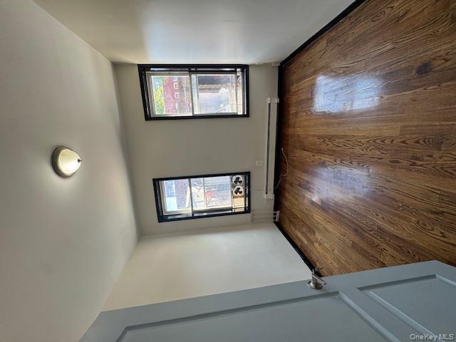 1586 Prospect Place, Unit 1R Brooklyn, NY 11233 - Photo 6 of 7 an empty room with wooden floor and windows