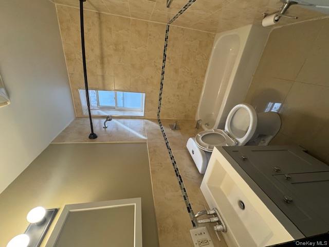 1586 Prospect Place, Unit 1R Brooklyn, NY 11233 - Photo 7 of 7 a bathroom with a sink a toilet and shower