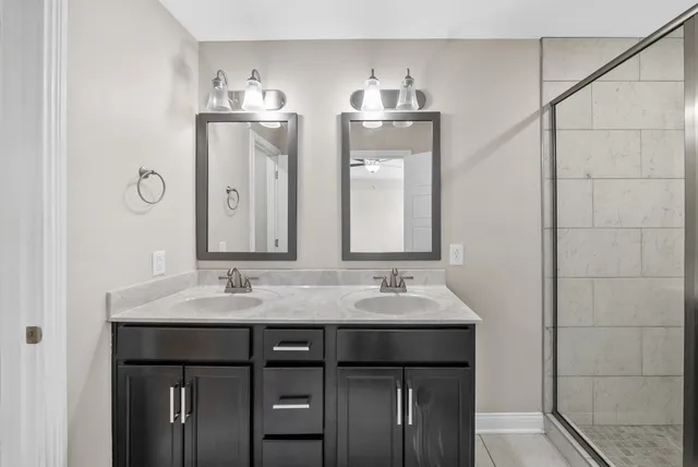 a bathroom with a double vanity sink and a mirror