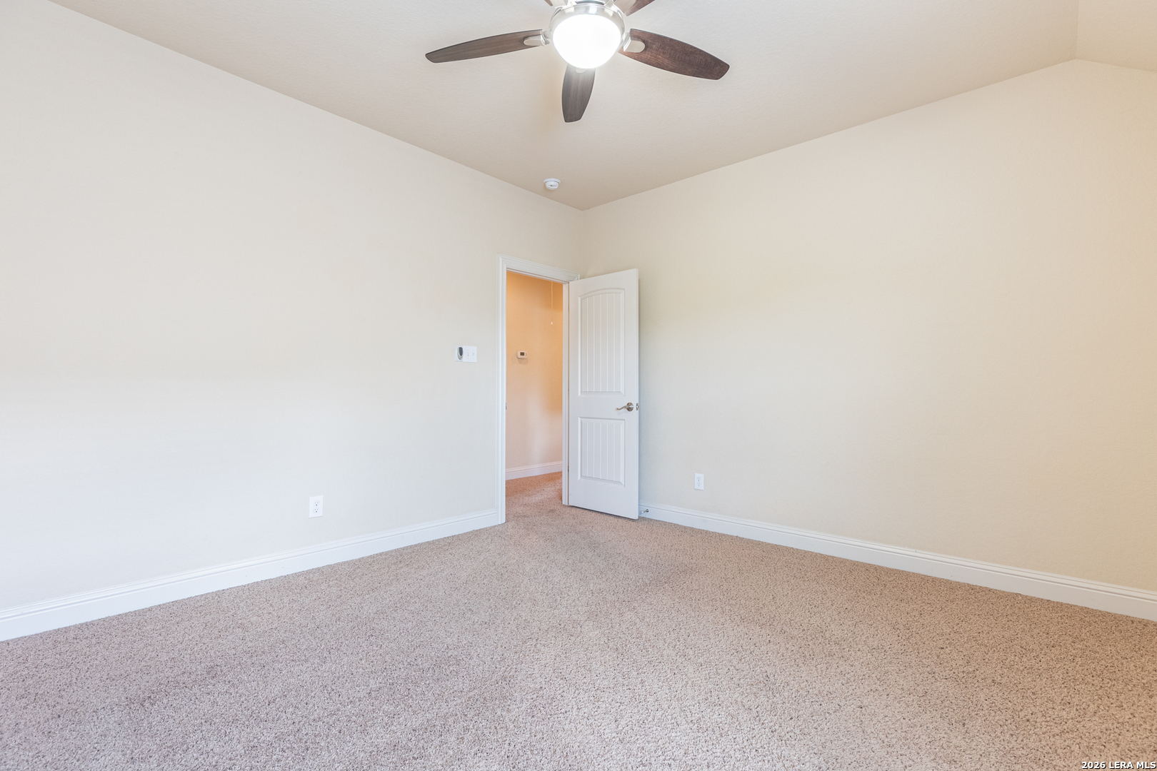 8103 Mystic Chase Boerne, TX 78015 - Photo 32 of 49 an empty room with a chandelier fan and windows