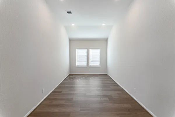 a view of an empty room and wooden floor