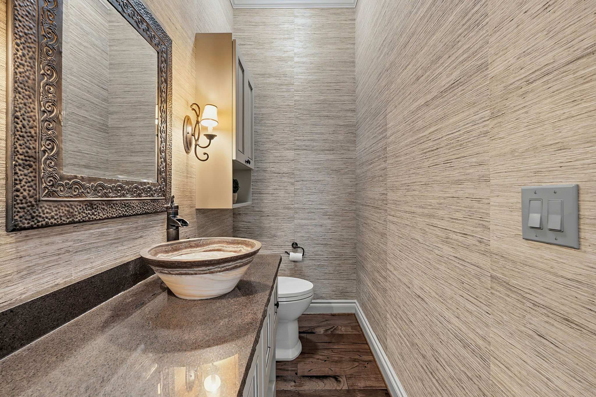 8121 Bluff Trail Austin, TX 78737 - Photo 16 of 40 A stylish half-bath features an ornamental mirror, vessel sink, and textured walls.