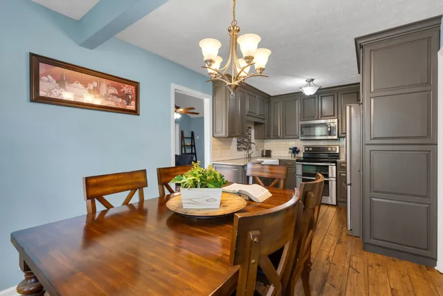 a kitchen with a table chairs and refrigerator