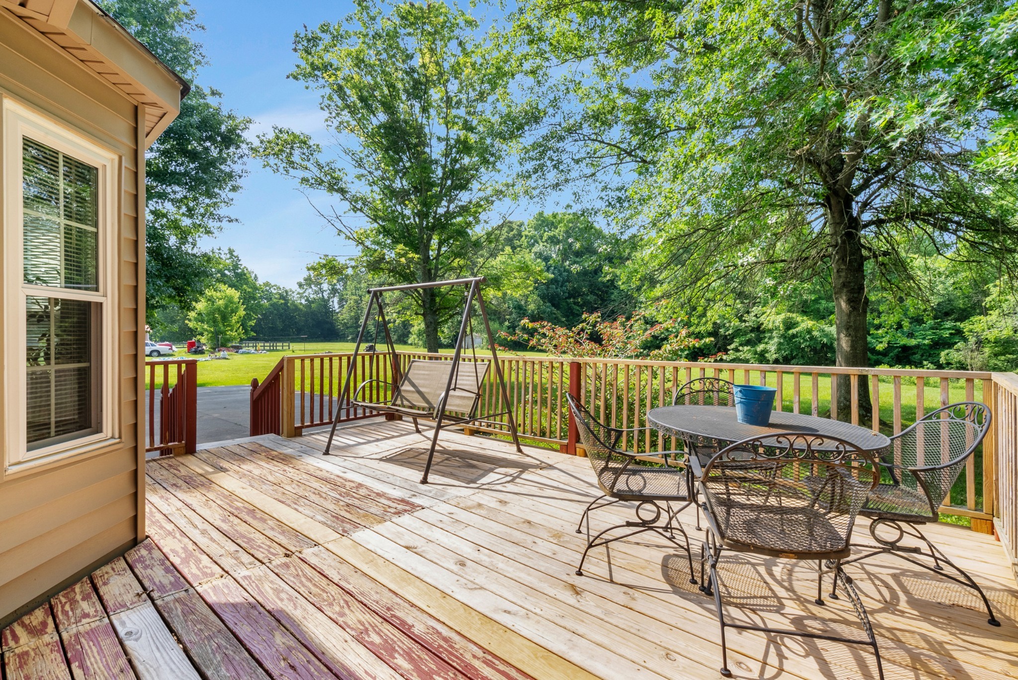 2220 Pleasant View Road Pleasant View, TN 37146 - Photo 28 of 34 a view of a deck with a table and chairs next to a yard with wooden floor and fence