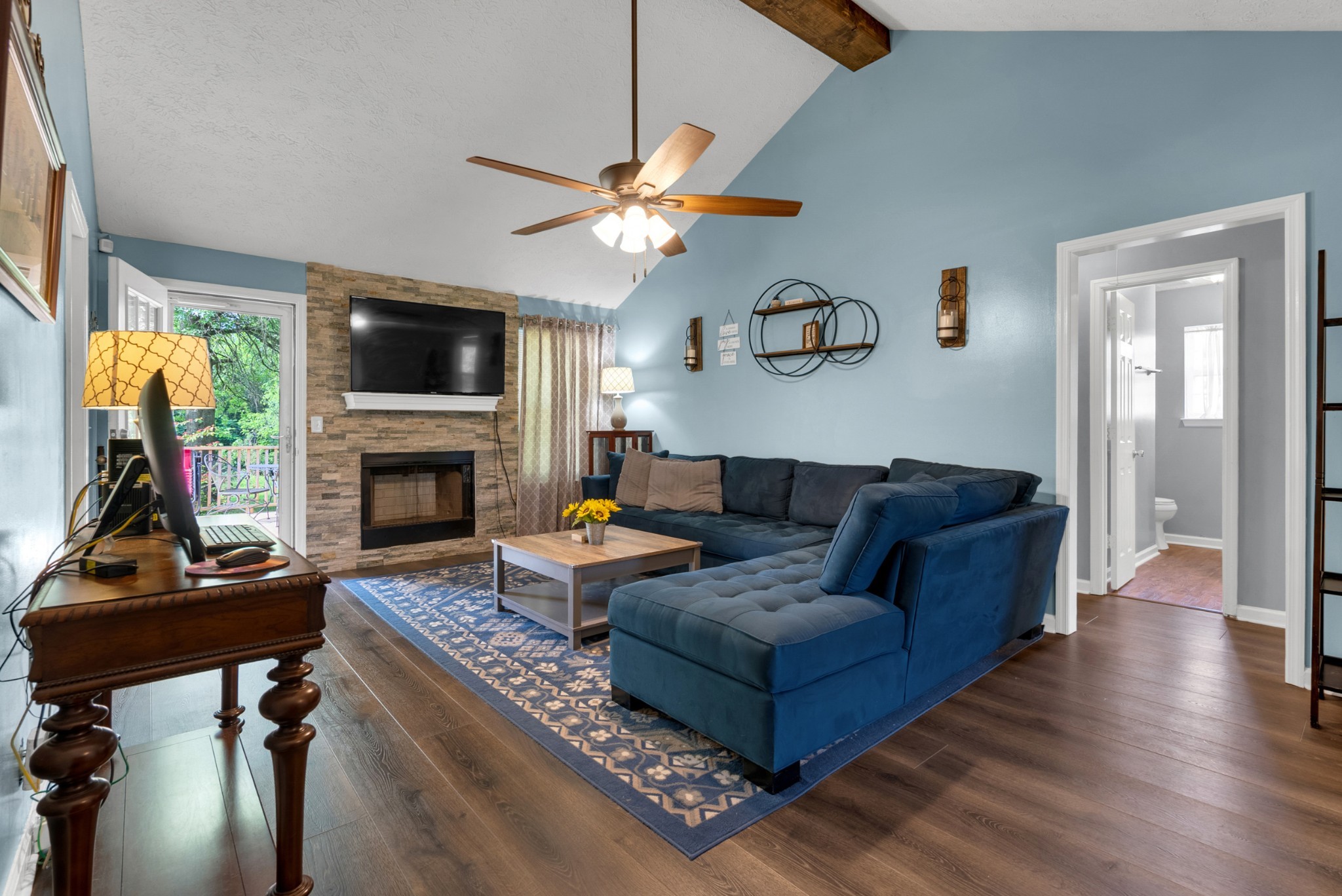2220 Pleasant View Road Pleasant View, TN 37146 - Photo 6 of 34 a living room with furniture a flat screen tv and a fireplace