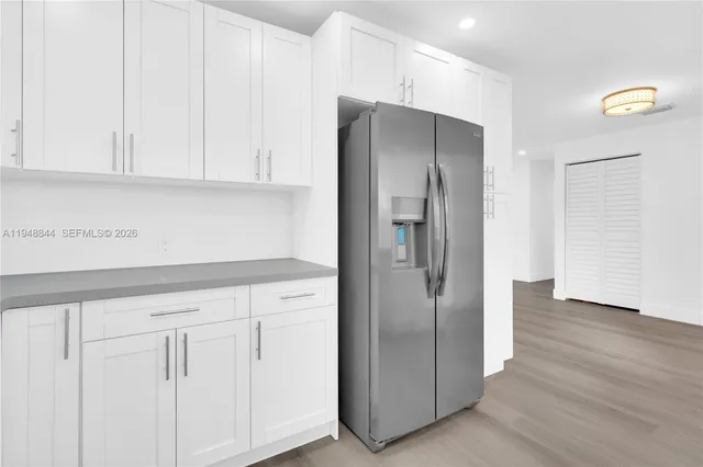 a kitchen with stainless steel appliances granite countertop a refrigerator and a sink