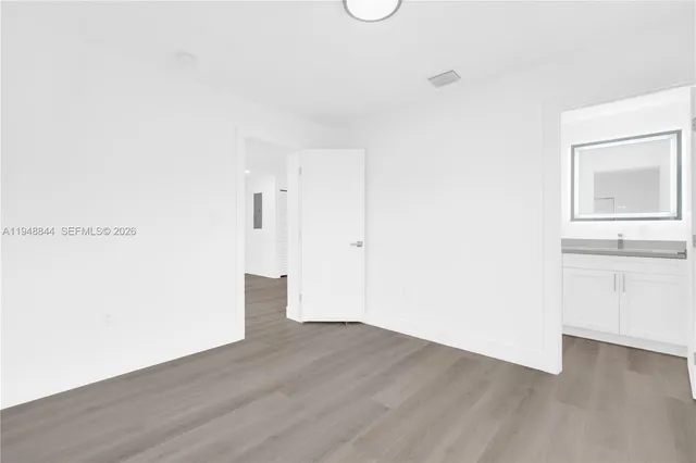 a view of a room with wooden floor