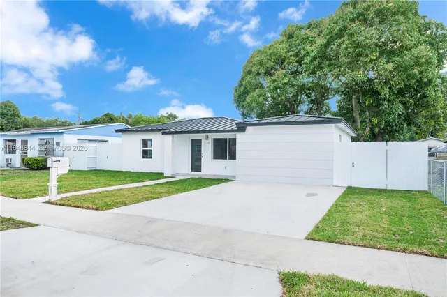 a view of backyard of house and car parked