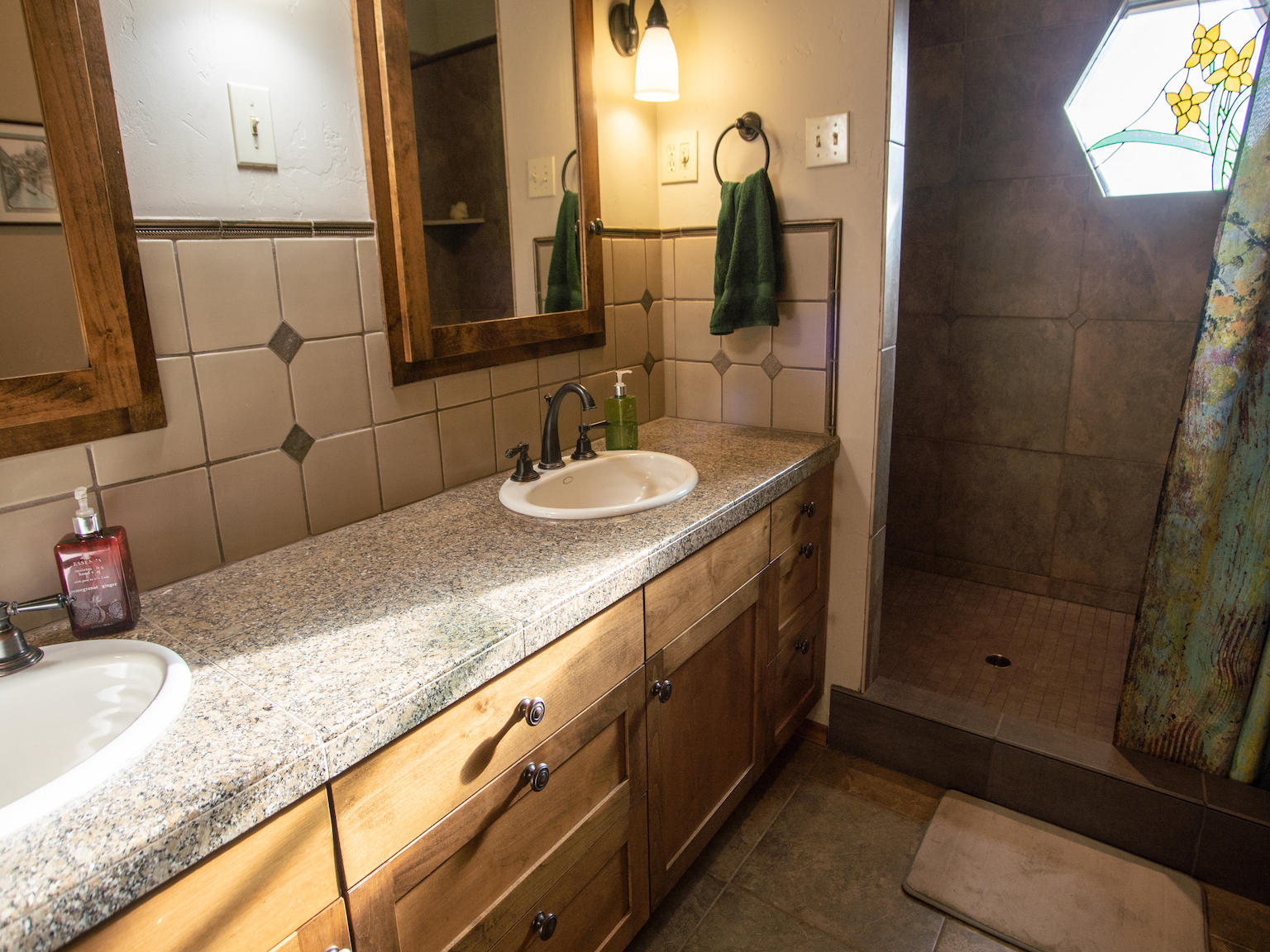 64295 Schibel Road Bend, OR 97703 - Photo 13 of 41 a bathroom with a granite countertop sink and a mirror