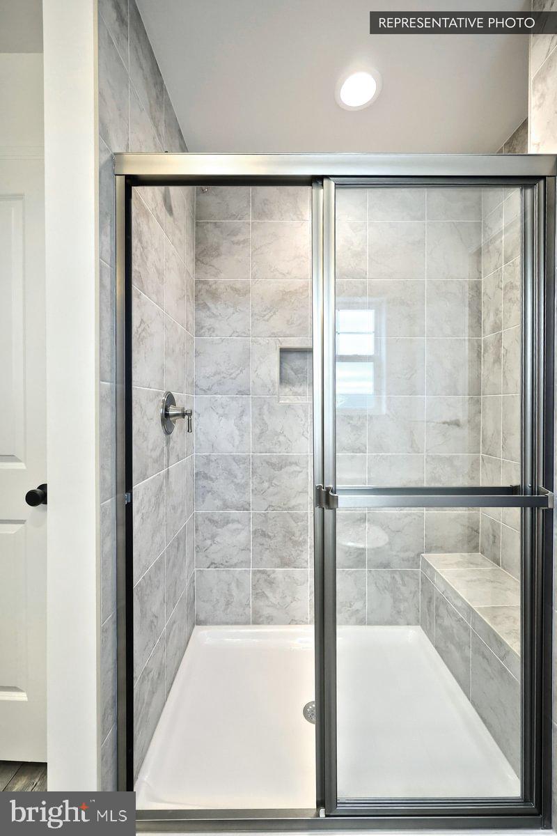 6328 Liam Drive Spring Grove, PA 17362 - Photo 16 of 18 a bathroom with a glass shower door