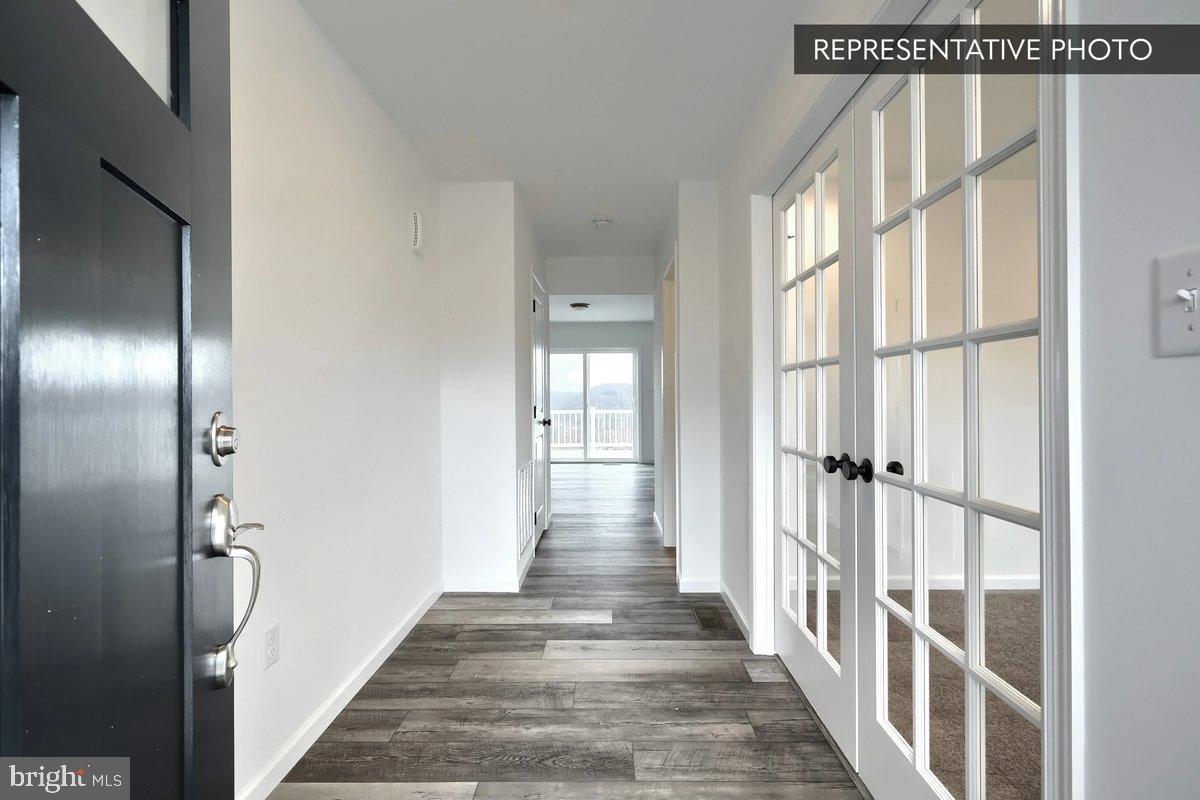 6328 Liam Drive Spring Grove, PA 17362 - Photo 3 of 18 a view of a hallway with wooden floor and windows