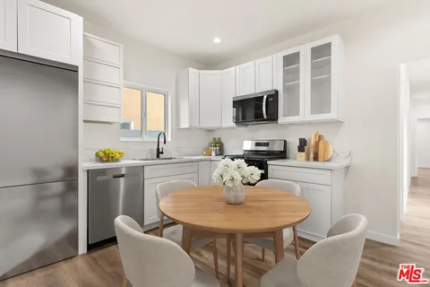 a kitchen with a sink cabinets and appliances