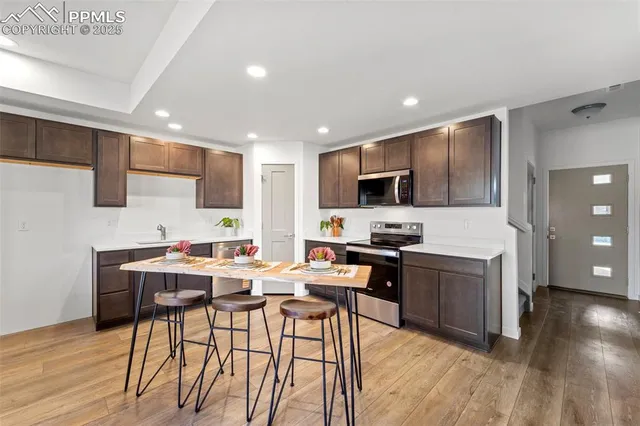 a view of kitchen with cabinets stainless steel appliances a sink and a counter top space