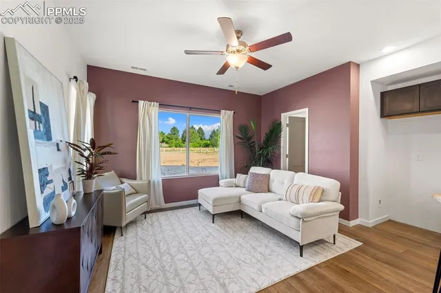 a living room with furniture and a large window