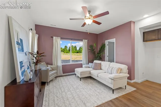 a living room with furniture and a large window