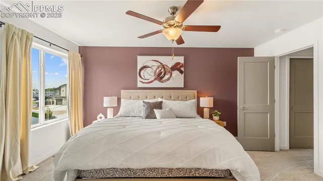 a bedroom with a large bed and a window