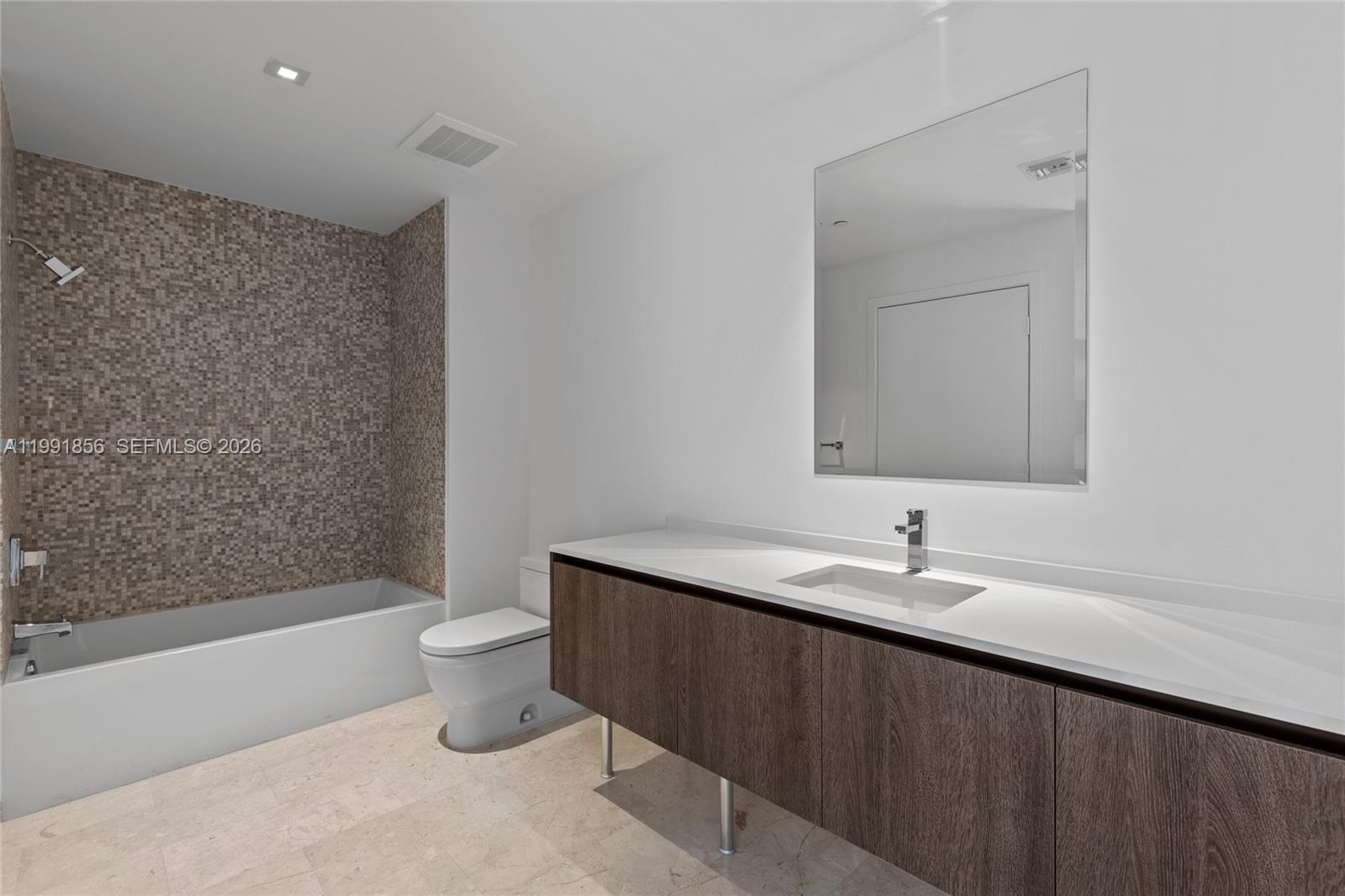 88 Southwest 7th Street, Unit 904 Miami, FL 33130 - Photo 17 of 26 a bathroom with a sink a toilet and a bathtub