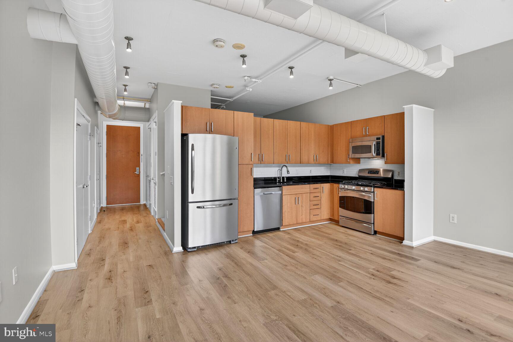 811 4th Street Northwest, Unit 503 Washington, DC 20001 - Photo 4 of 15 a kitchen with stainless steel appliances a refrigerator and a stove top oven