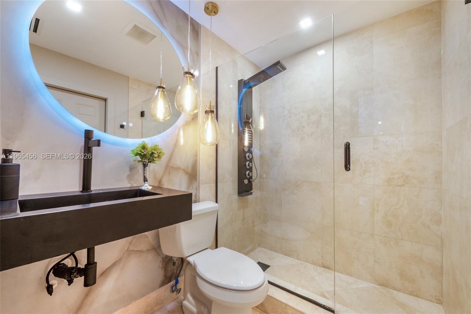 7401 Southwest 117th Street Pinecrest, FL 33156 - Photo 12 of 21 a bathroom with a sink mirror vanity and toilet