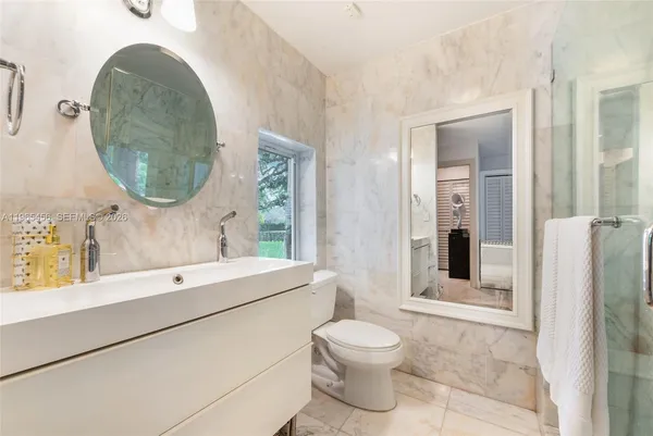 a bathroom with a toilet sink and tub