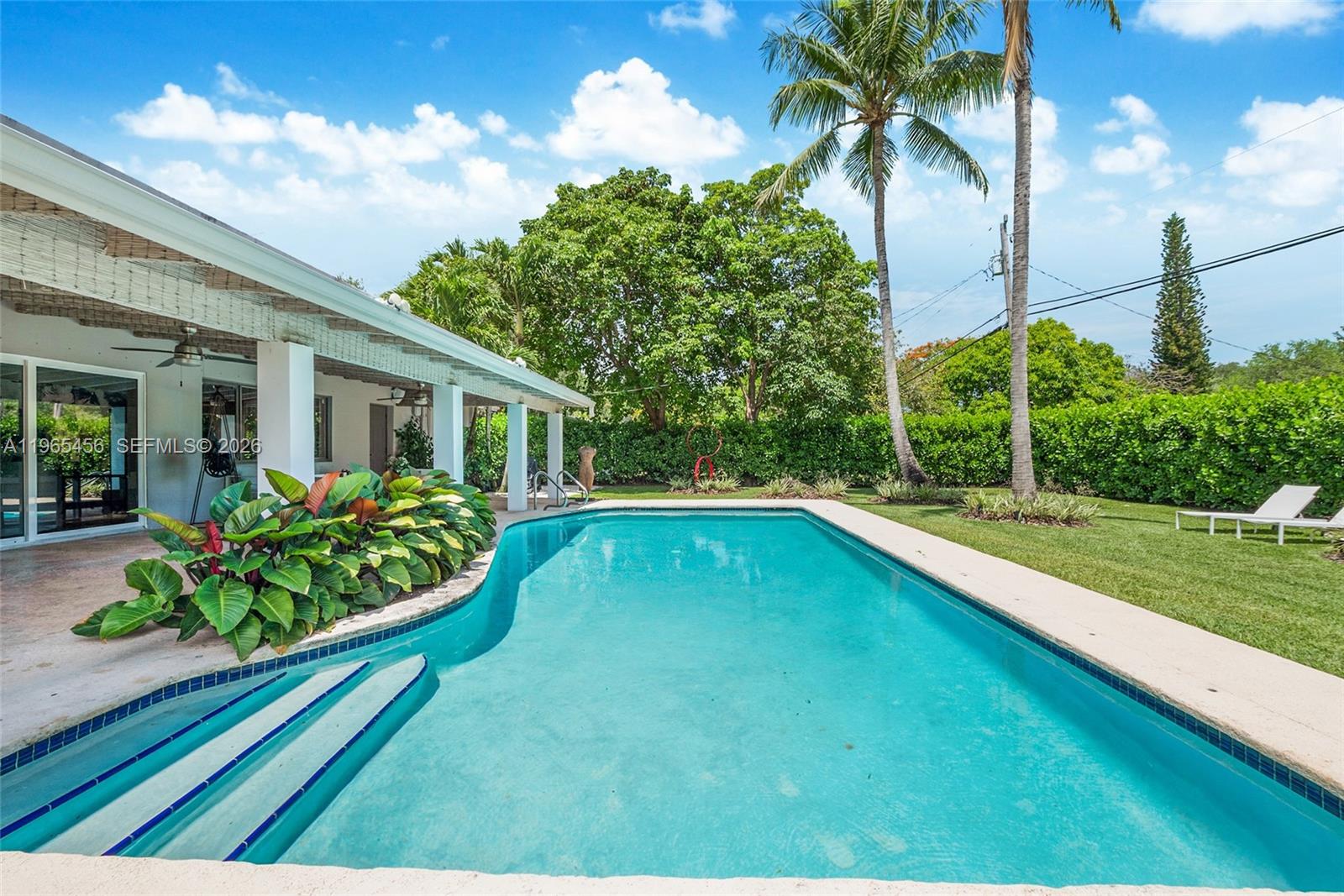 7401 Southwest 117th Street Pinecrest, FL 33156 - Photo 16 of 21 a swimming pool with outdoor seating and yard