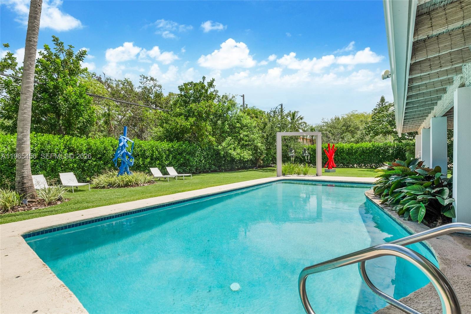 7401 Southwest 117th Street Pinecrest, FL 33156 - Photo 18 of 21 a view of a swimming pool with an outdoor seating