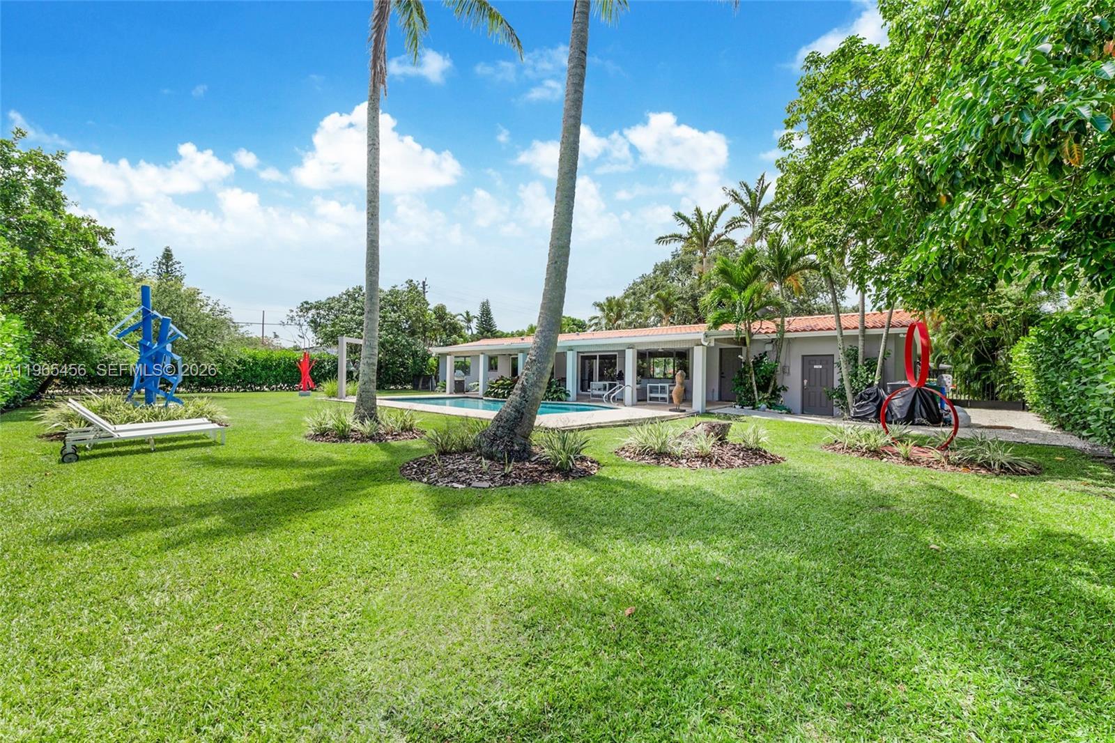 7401 Southwest 117th Street Pinecrest, FL 33156 - Photo 19 of 21 a view of a house with backyard sitting area and garden