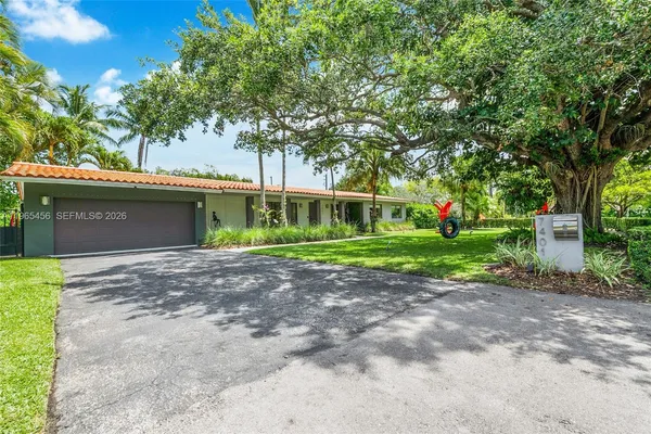 a view of a house with a yard and garage