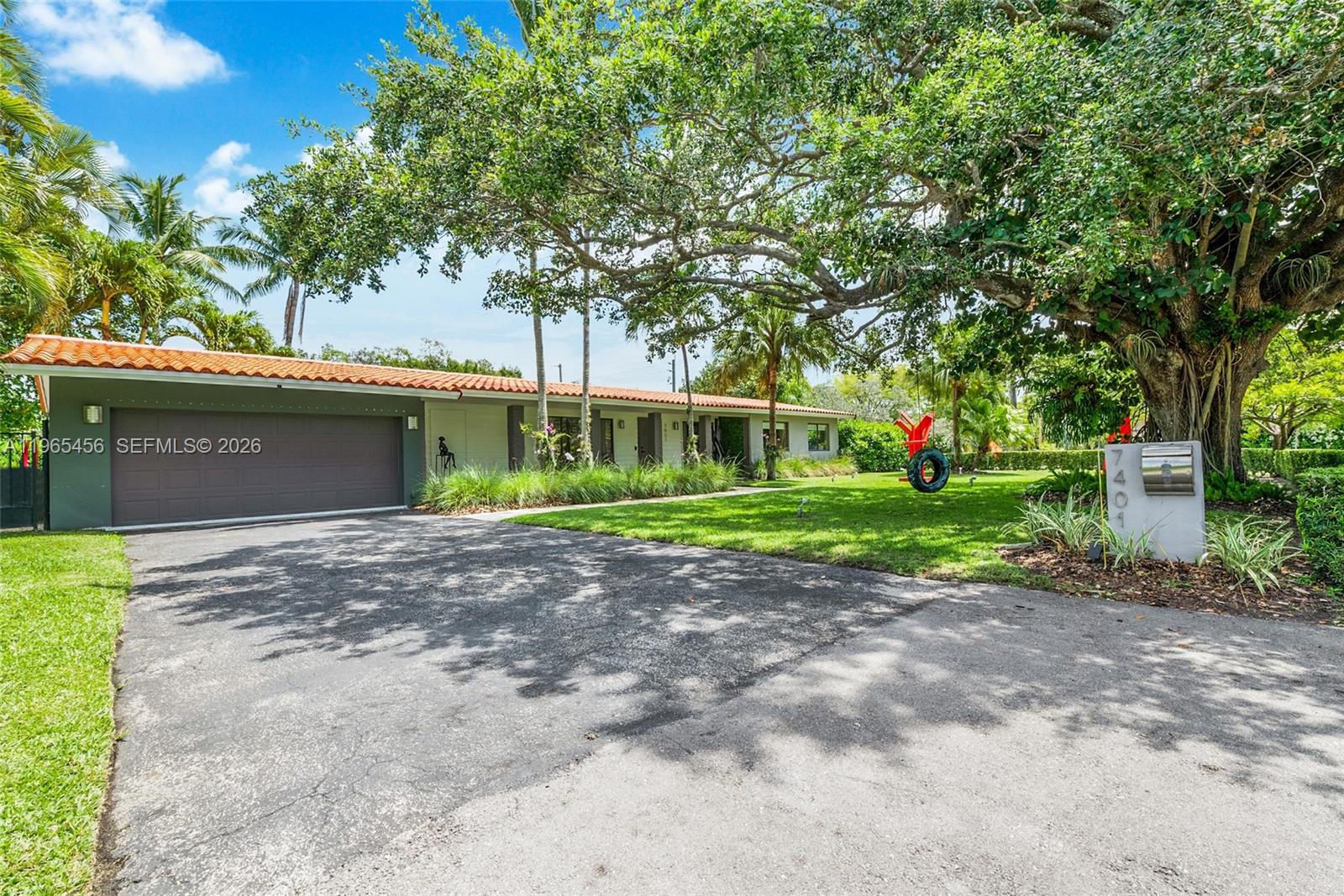7401 Southwest 117th Street Pinecrest, FL 33156 - Photo 20 of 21 a view of a house with a yard and garage