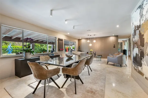 a view of a dining room with furniture window and outside view