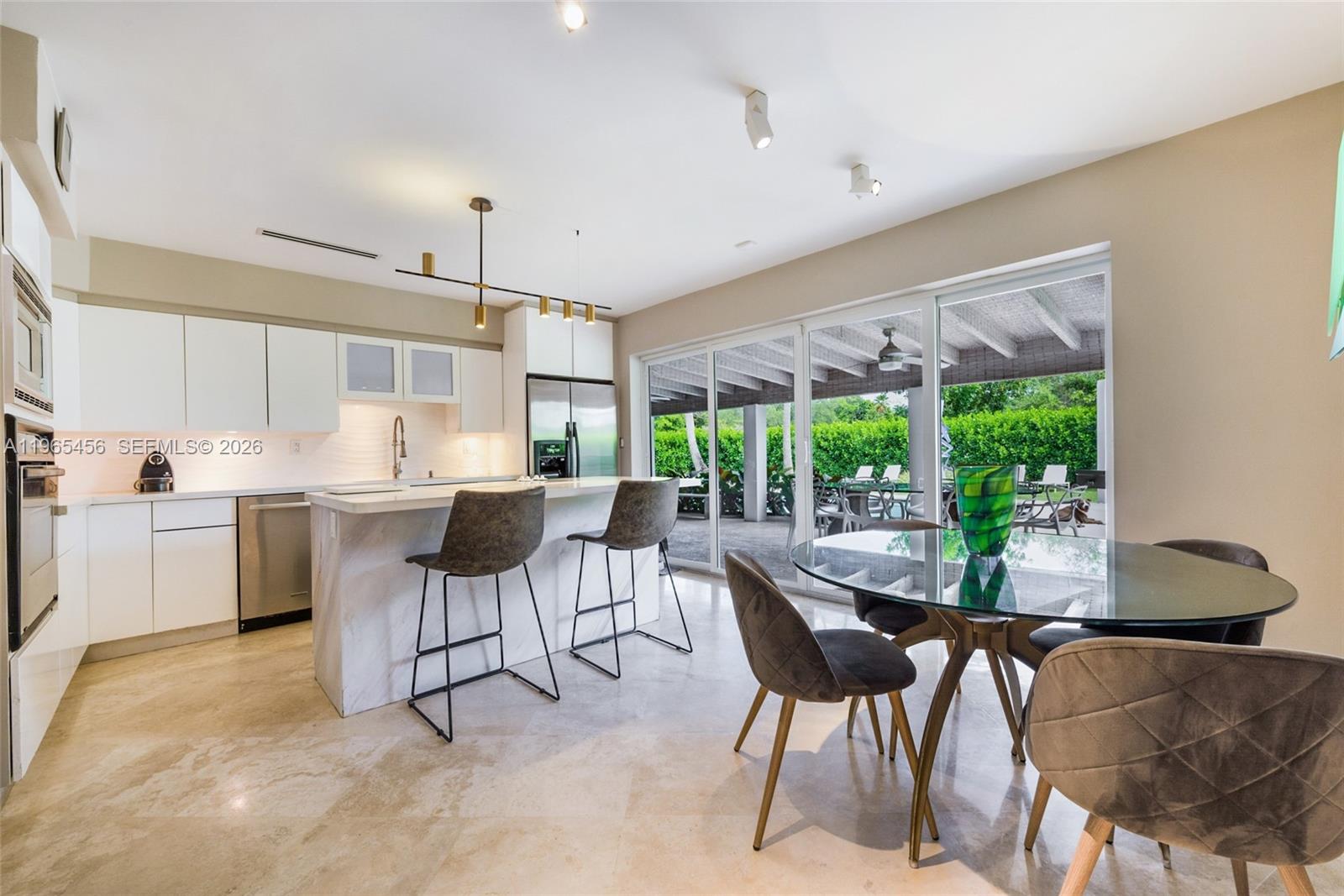7401 Southwest 117th Street Pinecrest, FL 33156 - Photo 6 of 21 a view of a dining room with furniture window and outside view