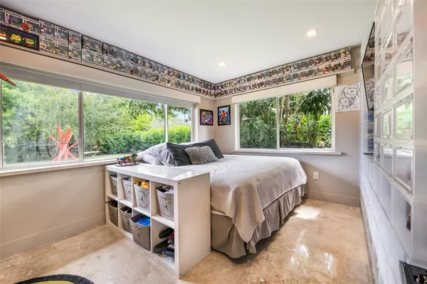 a bed room with a bed and a large window