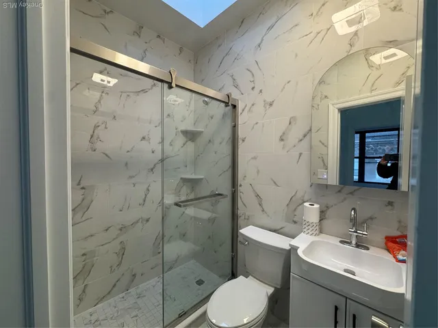 a bathroom with a sink toilet and shower