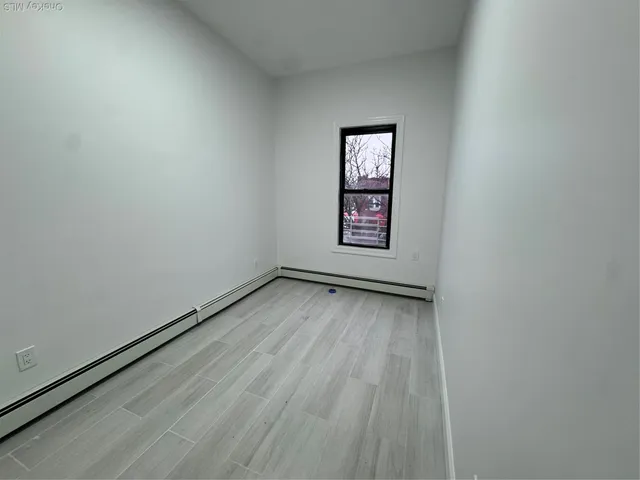 a view of wooden floor and windows in a room