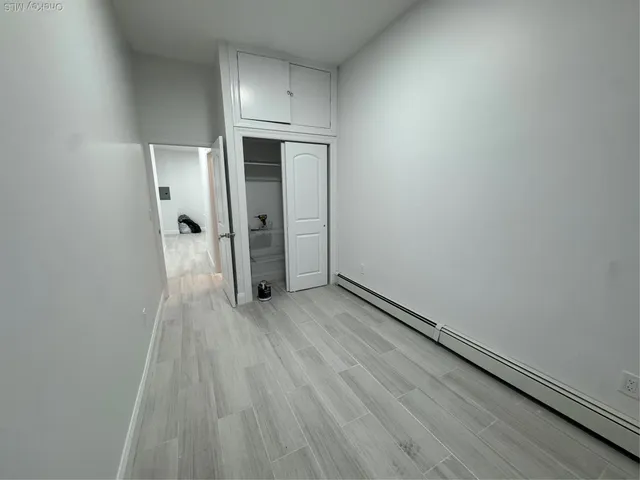 a view of hallway with wooden floor