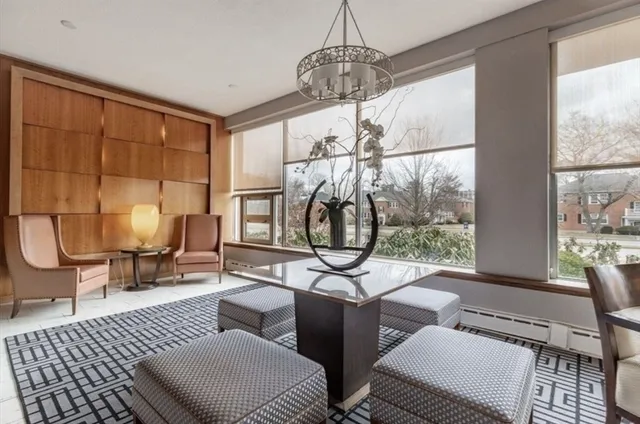 a living room with furniture a rug and a window