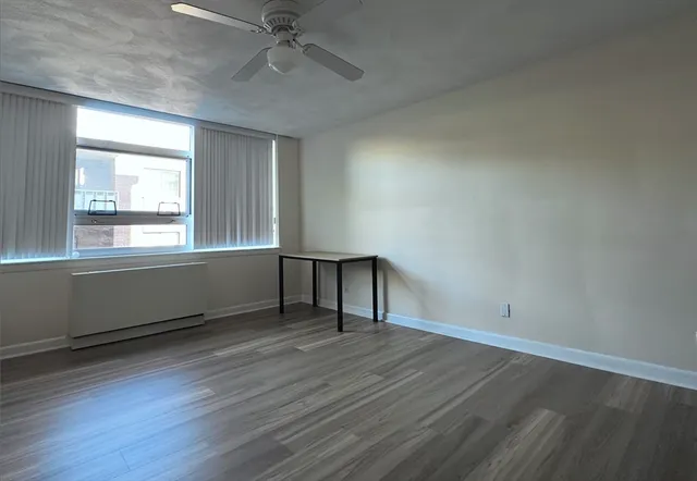 wooden floor in an empty room with a window