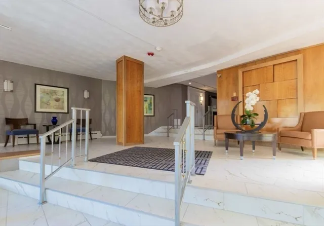 a living room with furniture a table and large windows