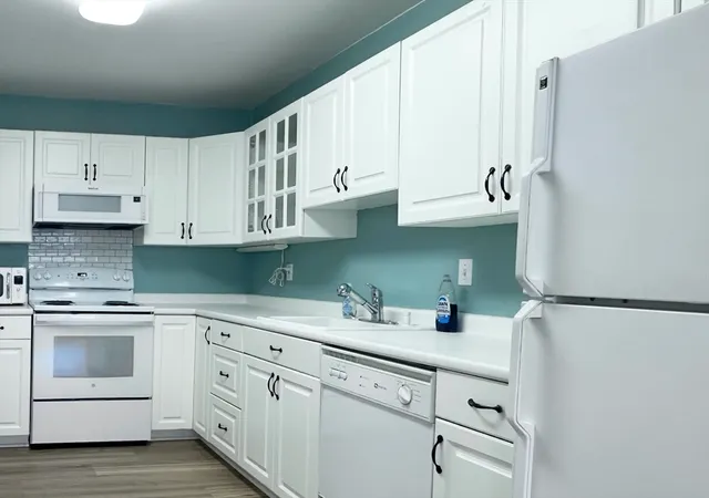 a kitchen with stainless steel appliances granite countertop a sink and a stove