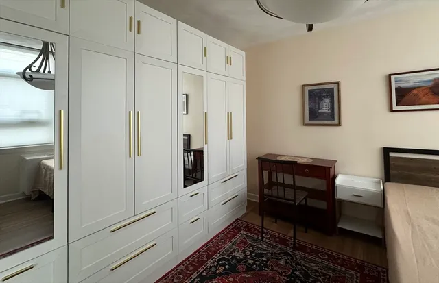 a room with furniture a rug and a window