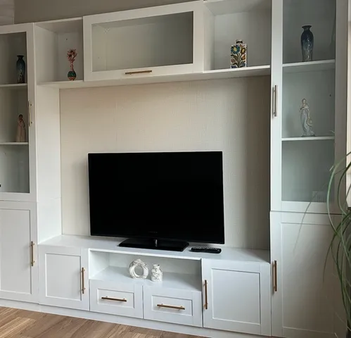 a living room with a fireplace and a flat screen tv
